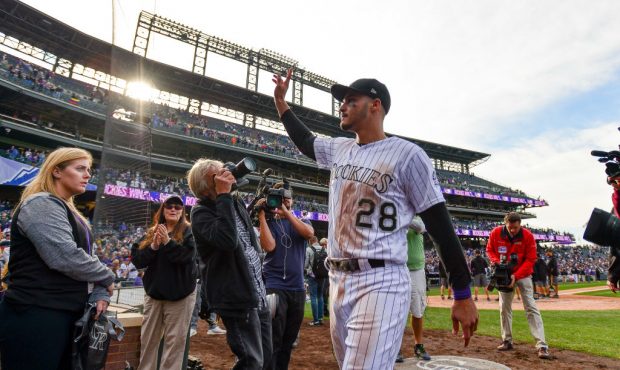 DENVER, CO - SEPTEMBER 30:  Nolan Arenado #28 of the Colorado Rockies waves to the crowd after walk...
