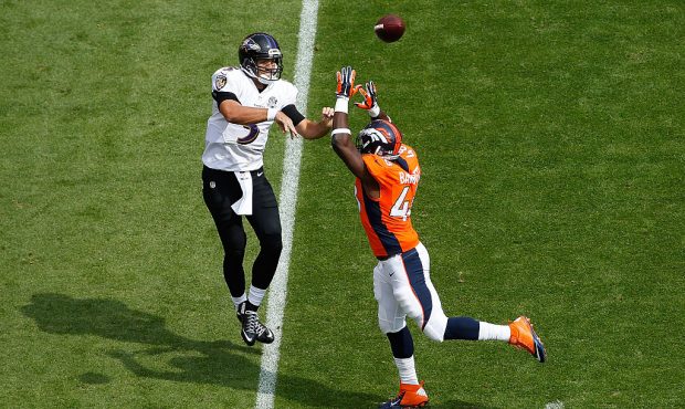 DENVER, CO - SEPTEMBER 13:  Quarterback Joe Flacco #5 of the Baltimore Ravens gets off a pass again...