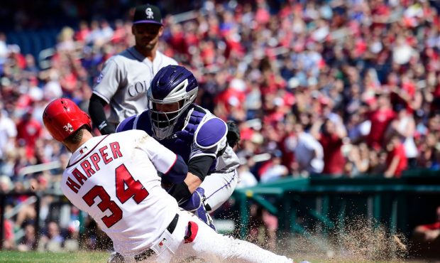 WASHINGTON, DC - APRIL 14: Bryce Harper #34 of the Washington Nationals slides in safely to score a...