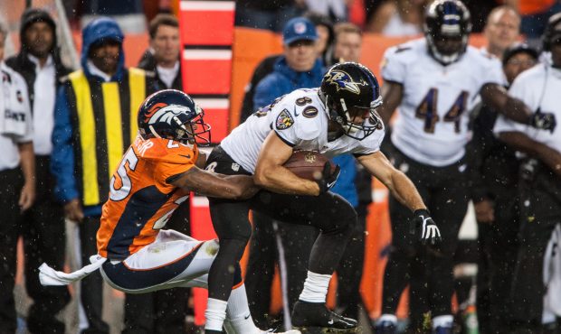 DENVER, CO - SEPTEMBER 5: Cornerback Chris Harris #25 of the Denver Broncos tackles wide receiver B...