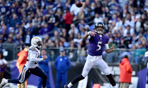 Quarterback Joe Flacco #5 of the Baltimore Ravens throws after being forced out of the pocket by fr...