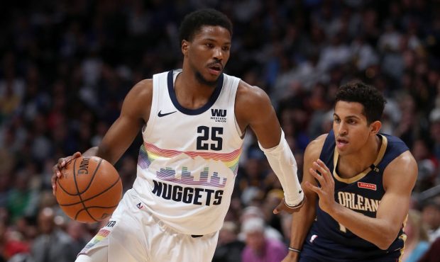 DENVER, COLORADO - MARCH 02: Malik Beasley #25 of the Denver Nuggets drives against Frank Jackson #...