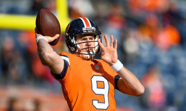 DENVER, CO - NOVEMBER 25:  Quarterback Kevin Hogan #9 of the Denver Broncos throws as he warms up b...