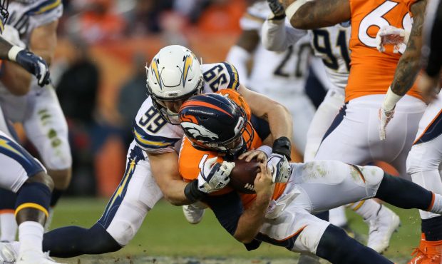 DENVER, CO - DECEMBER 30:  Quarterback Case Keenum #4 of the Denver Broncos is sacked by defensive ...