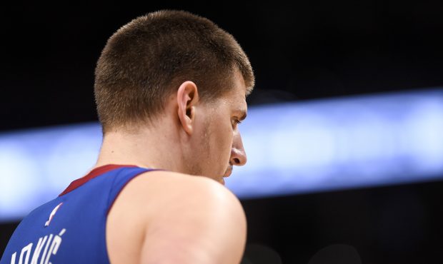 Nikola Jokic (15) of the Denver Nuggets takes a breather against the San Antonio Spurs during the t...