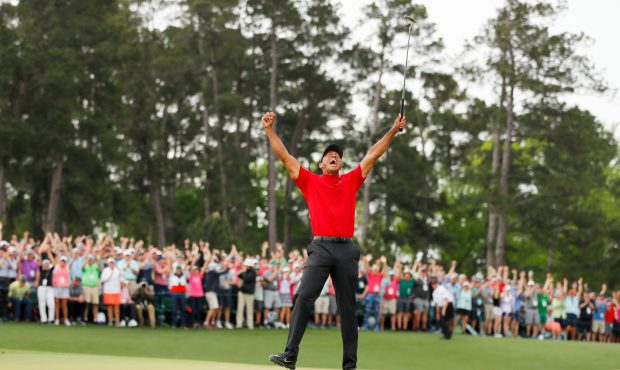 AUGUSTA, GEORGIA - APRIL 14: (Sequence frame 6 of 12) Tiger Woods of the United States celebrates a...