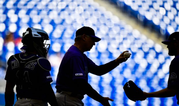 MIAMI, FL - MARCH 31: Bud Black #10 of the Colorado Rockies hands the ball to Harrison Musgrave #59...