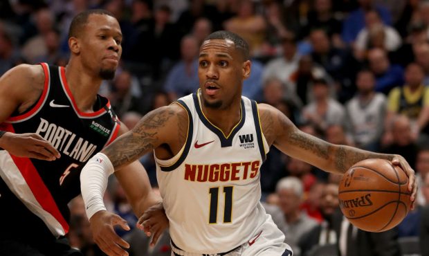 DENVER, COLORADO - APRIL 29: Monte Morris #11 of the Denver Nuggets drives against Rodney Hood #5 o...