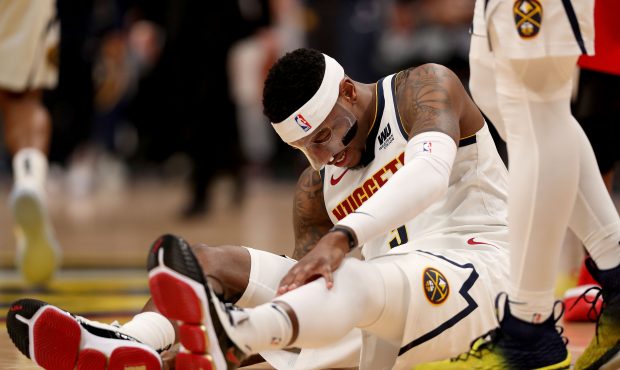 DENVER, COLORADO - MAY 01: Torrey Craig #3 of the Denver Nuggets is knocked to the floor against th...