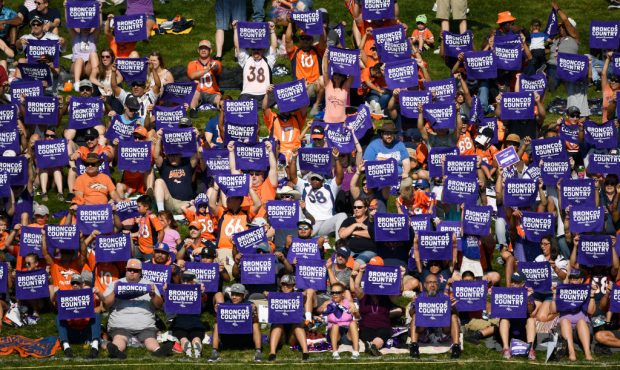 Denver Broncos fans hold purple towels in honor of Alzheimer's Awareness Day at training camp at Do...