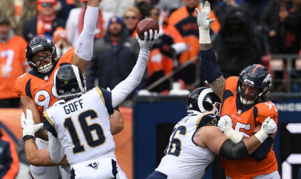 Denver Broncos Adam Gotsis #99, left, and Derek Wolfe #95 get hands up to cause an incomplete pass ...