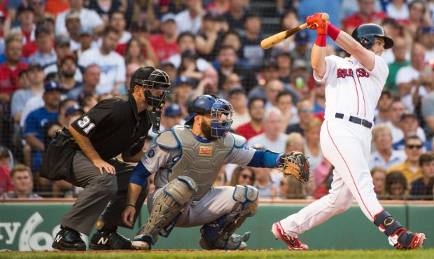 Andrew Benintendi #16 of the Boston Red Sox hits a two RBI single in the first inning against the L...