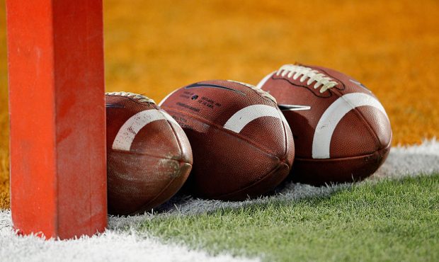A detail of a Nike official NCAA size footballs as they sit in the end zone prior to the West Virgi...