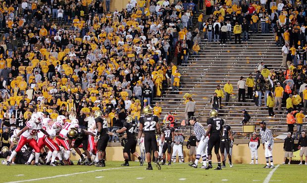 The Nebraska Cornhuskers miss a field goal attempt as security workers clear two sections of stands...