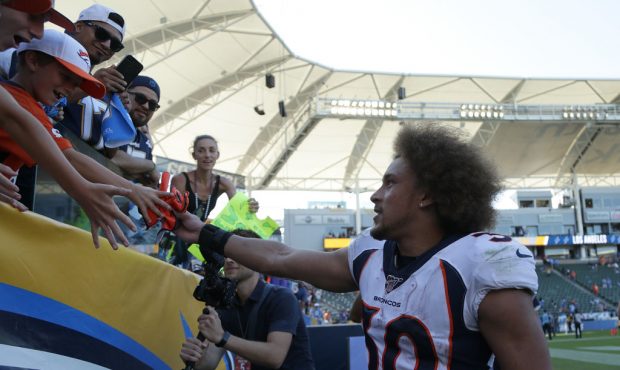 CARSON, CALIFORNIA - OCTOBER 06: Phillip Lindsay #30 of the Denver Broncos gives his glove to a fan...