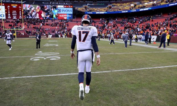 LANDOVER, MD - DECEMBER 24: Quarterback Brock Osweiler #17 of the Denver Broncos walks off the fiel...