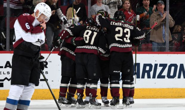 Phil Kessel #81 and Oliver Ekman-Larsson #23 of the Arizona Coyotes celebrate with teammates around...