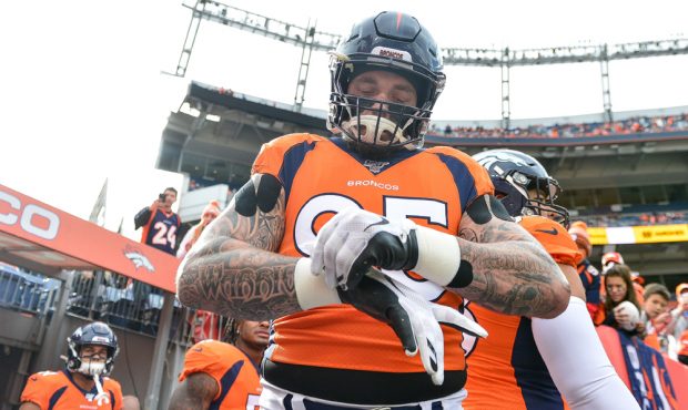 DENVER, CO - NOVEMBER 3: Derek Wolfe #95 of the Denver Broncos adjusts his gloves as he takes the f...