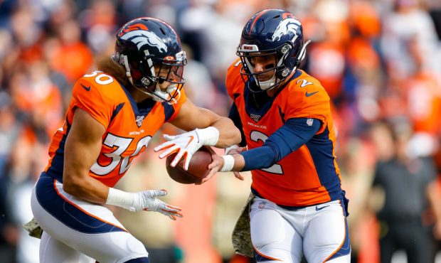 DENVER, CO - NOVEMBER 3:  Quarterback Brandon Allen #2 of the Denver Broncos hands the football off...