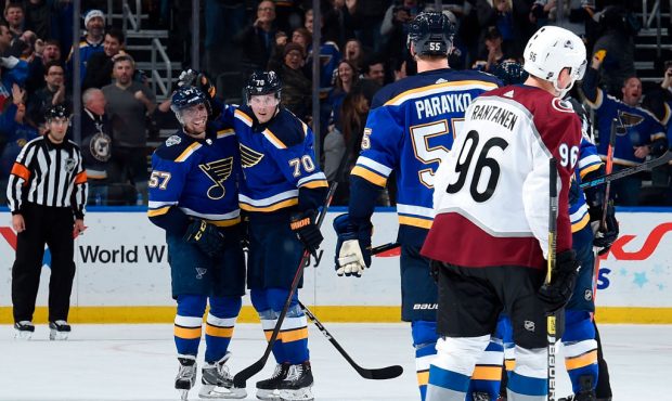 ST. LOUIS, MO - DECEMBER 16: David Perron #57 of the St. Louis Blue is congratulated by teammates a...