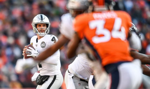 DENVER, CO - DECEMBER 29: Derek Carr #4 of the Oakland Raiders sets to pass against the Denver Bron...