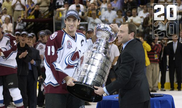 Joe Sakic #19 of the Colorado Avalanche and commissioner Gary Bettman hold the Stanley Cup after th...