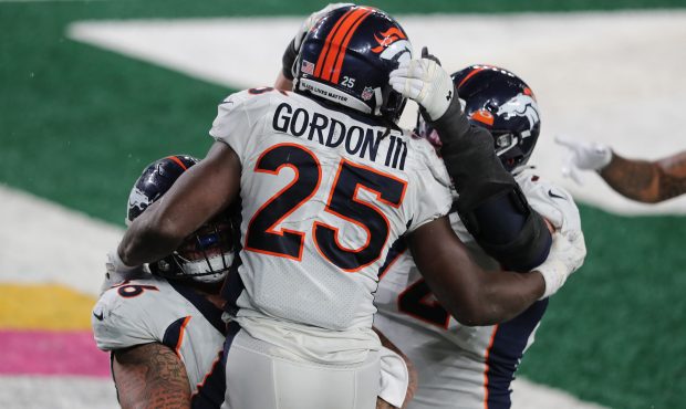 EAST RUTHERFORD, NEW JERSEY - OCTOBER 01: Melvin Gordon #25 of the Denver Broncos is congratulated ...