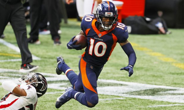 Jerry Jeudy #10 of the Denver Broncos is tackled by Kendall Sheffield #20 of the Atlanta Falcons du...