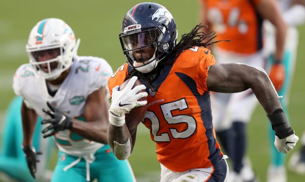 DENVER, COLORADO - NOVEMBER 22: Melvin Gordon #25 of the Denver Broncos carries the ball for a touc...