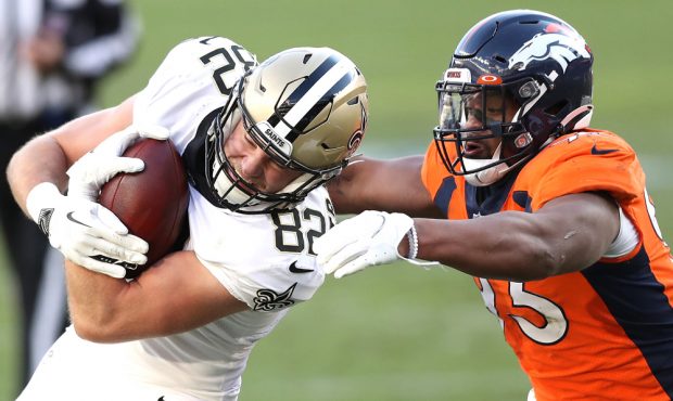 DENVER, COLORADO - NOVEMBER 29: Adam Trautman #82 of the New Orleans Saints rushes under pressure f...