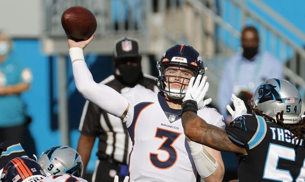 CHARLOTTE, NORTH CAROLINA - DECEMBER 13: Drew Lock #3 of the Denver Broncos attempts a pass against...