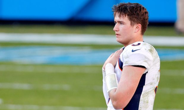 CHARLOTTE, NORTH CAROLINA - DECEMBER 13: Drew Lock #3 of the Denver Broncos looks on against the Ca...