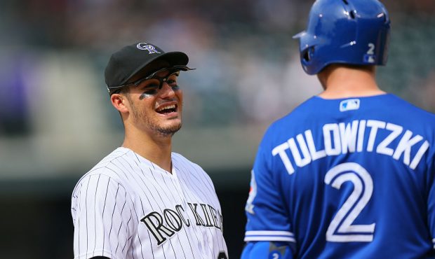 DENVER, CO - JUNE 29: Nolan Arenado #28 of the Colorado Rockies shares a laugh with former teammate...