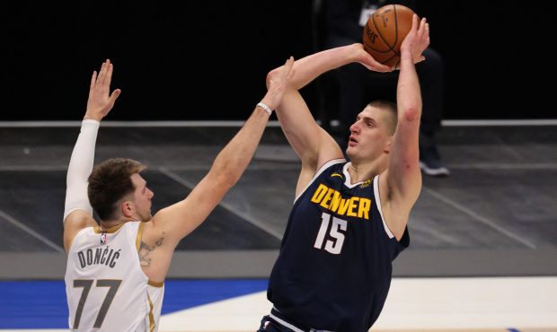 DALLAS, TEXAS - JANUARY 25: Nikola Jokic #15 of the Denver Nuggets takes a shot against Luka Doncic...