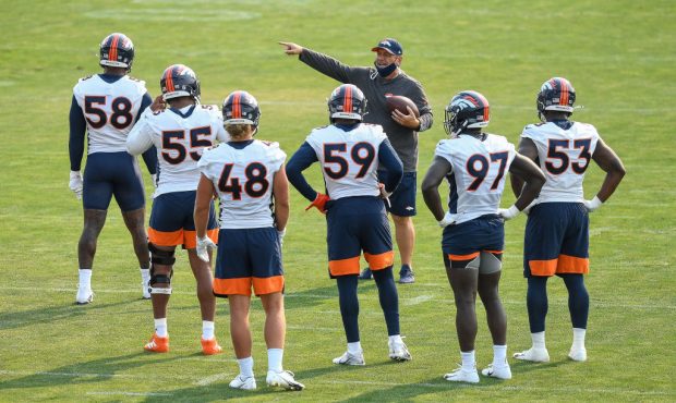 ENGLEWOOD, CO - AUGUST 16: Outside linebackers coach John Pagano of the Denver Broncos works with p...