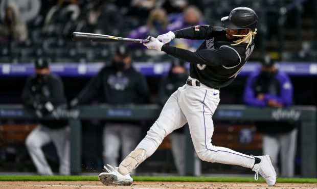 DENVER, CO - APRIL 6: Raimel Tapia #15 of the Colorado Rockies hits a first inning single against t...