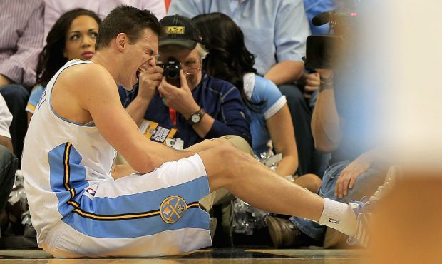 DENVER, CO - APRIL 04: Danilo Gallinari #8 of the Denver Nuggets grimaces as he injures his left kn...