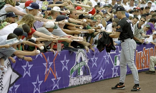 7 Jul 1998: American League member Cal Ripken Jr. #8 of the Baltimore Orioles signs autographs for ...