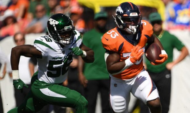 DENVER, COLORADO - SEPTEMBER 26: New York Jets outside linebacker Quincy Williams (56), left, chase...