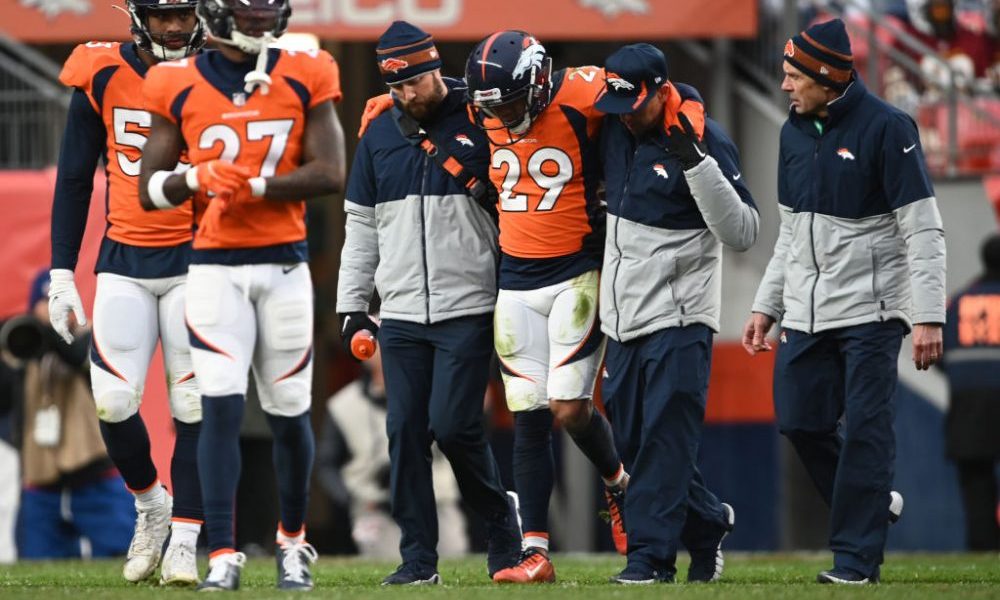 DENVER, COLORADO - OCTOBER 31: Denver Broncos cornerback Bryce Callahan (29) is helped off the fiel...