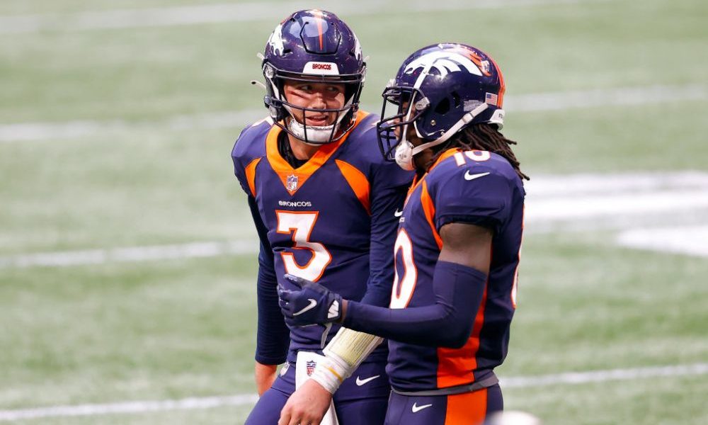 ATLANTA, GEORGIA - NOVEMBER 08: Drew Lock #3 of the Denver Broncos talks with Jerry Jeudy #10 durin...