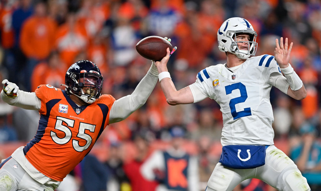 DENVER, COLORADO - OCTOBER 06: Matt Ryan #2 of the Indianapolis Colts is pressured by Baron Brownin...