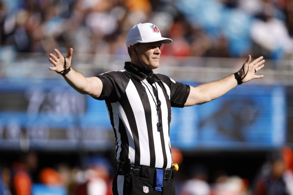 CHARLOTTE, NORTH CAROLINA - NOVEMBER 27: Referee Clay Martin #19 makes a call during the first half...