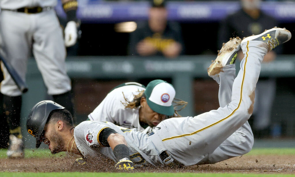 DENVER, COLORADO - APRIL 18: Tucupita Marcano #30 of the Pittsburgh Pirates steal home on a wild pi...
