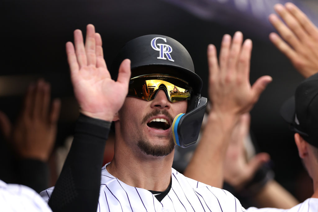 DENVER, COLORADO - MAY 04: Brenton Doyle #9 of the Colorado Rockies celebrates in the dugout after ...