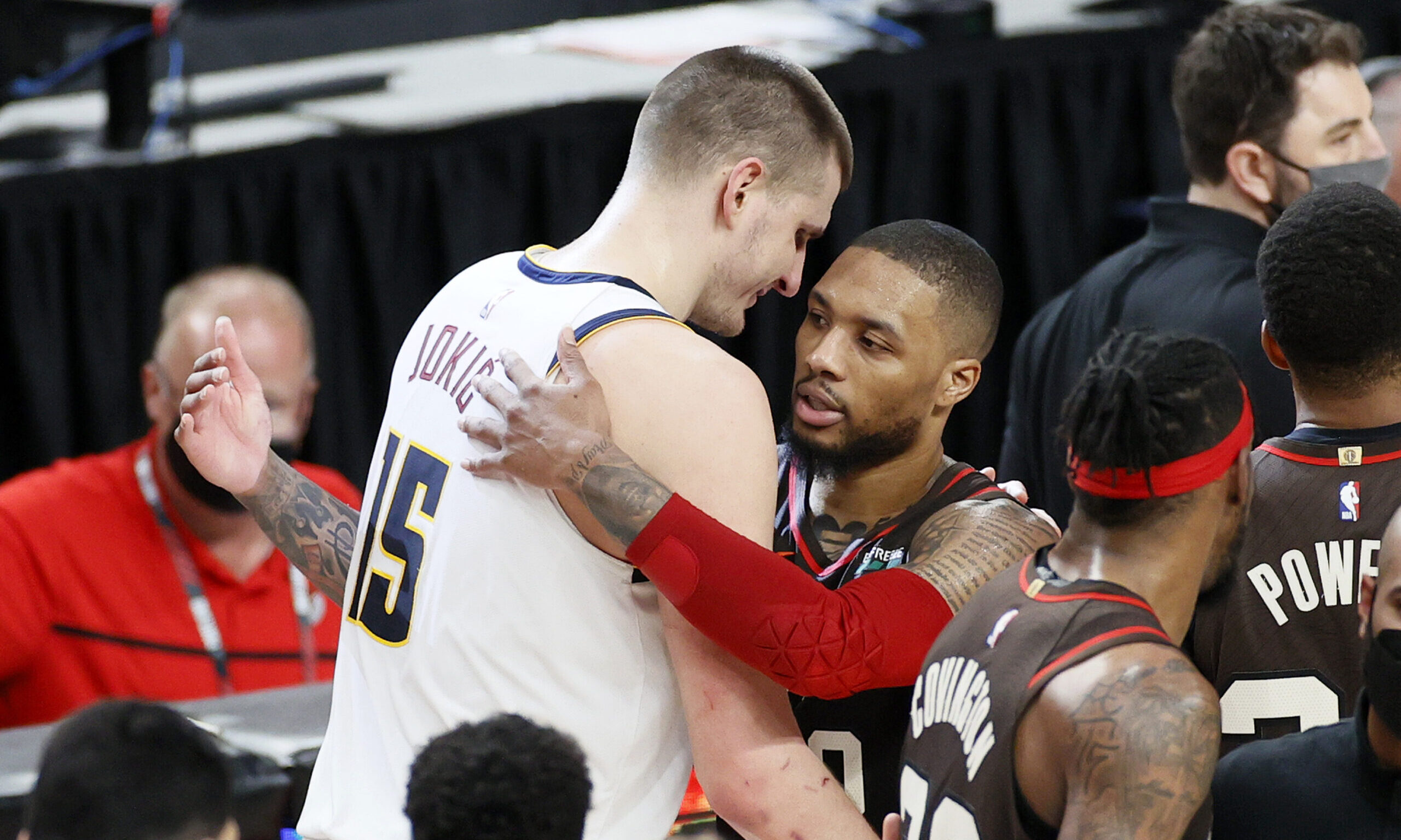 Nikola Jokic #15 of the Denver Nuggets and Damian Lillard #0 of the Portland Trail Blazers...