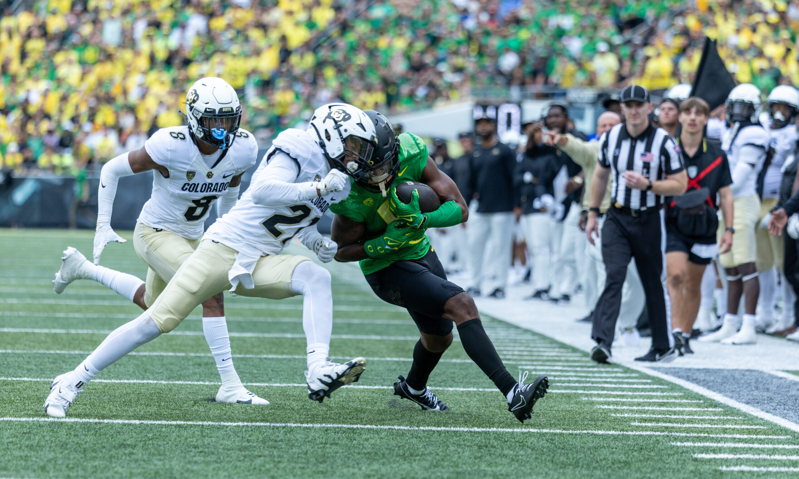 Wide receiver Traeshon Holden #5 of the Oregon Ducks collides with safety Shilo Sanders #21 of the ...