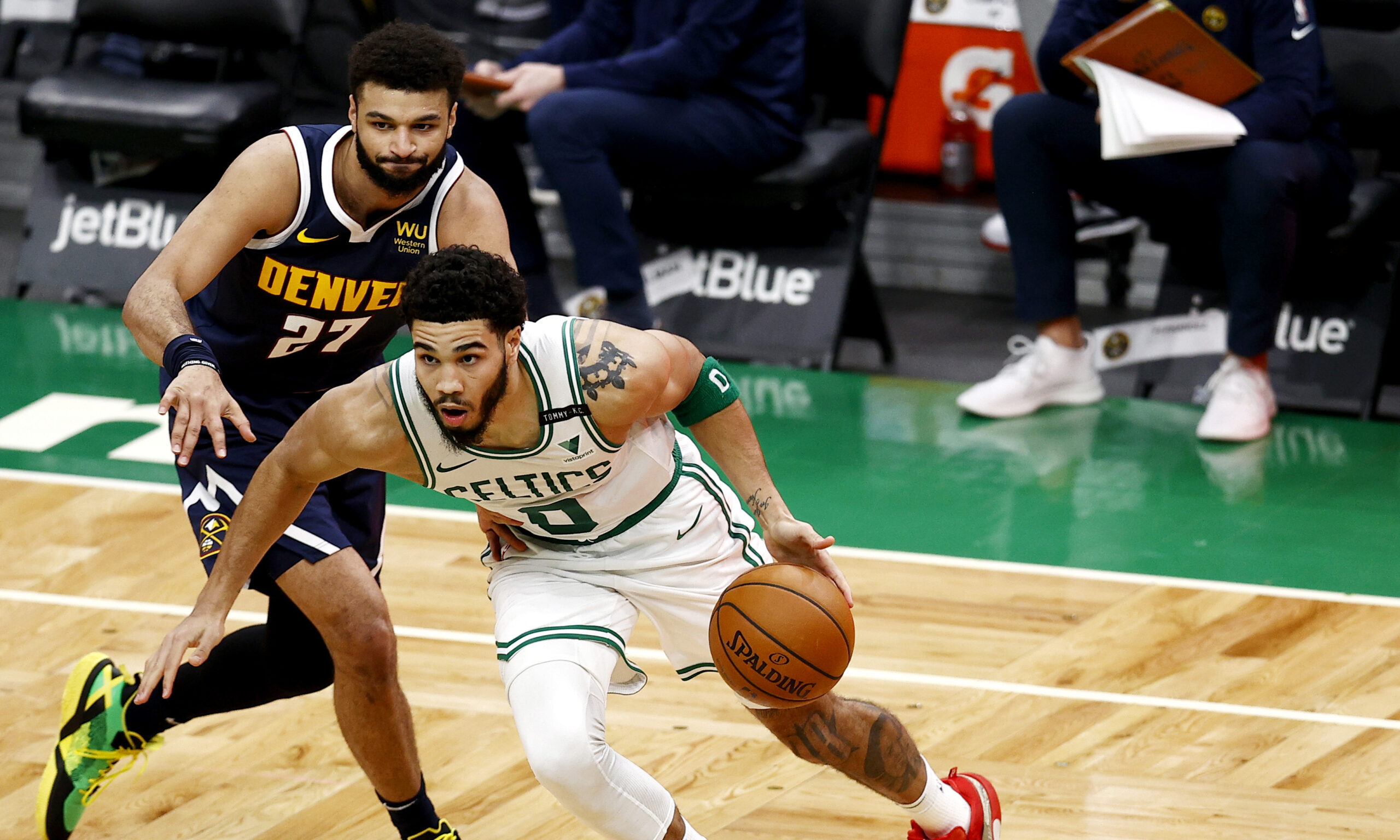 Jayson Tatum #0 of the Boston Celtics drives to the basket past Jamal Murray #27 of the Denver Nugg...