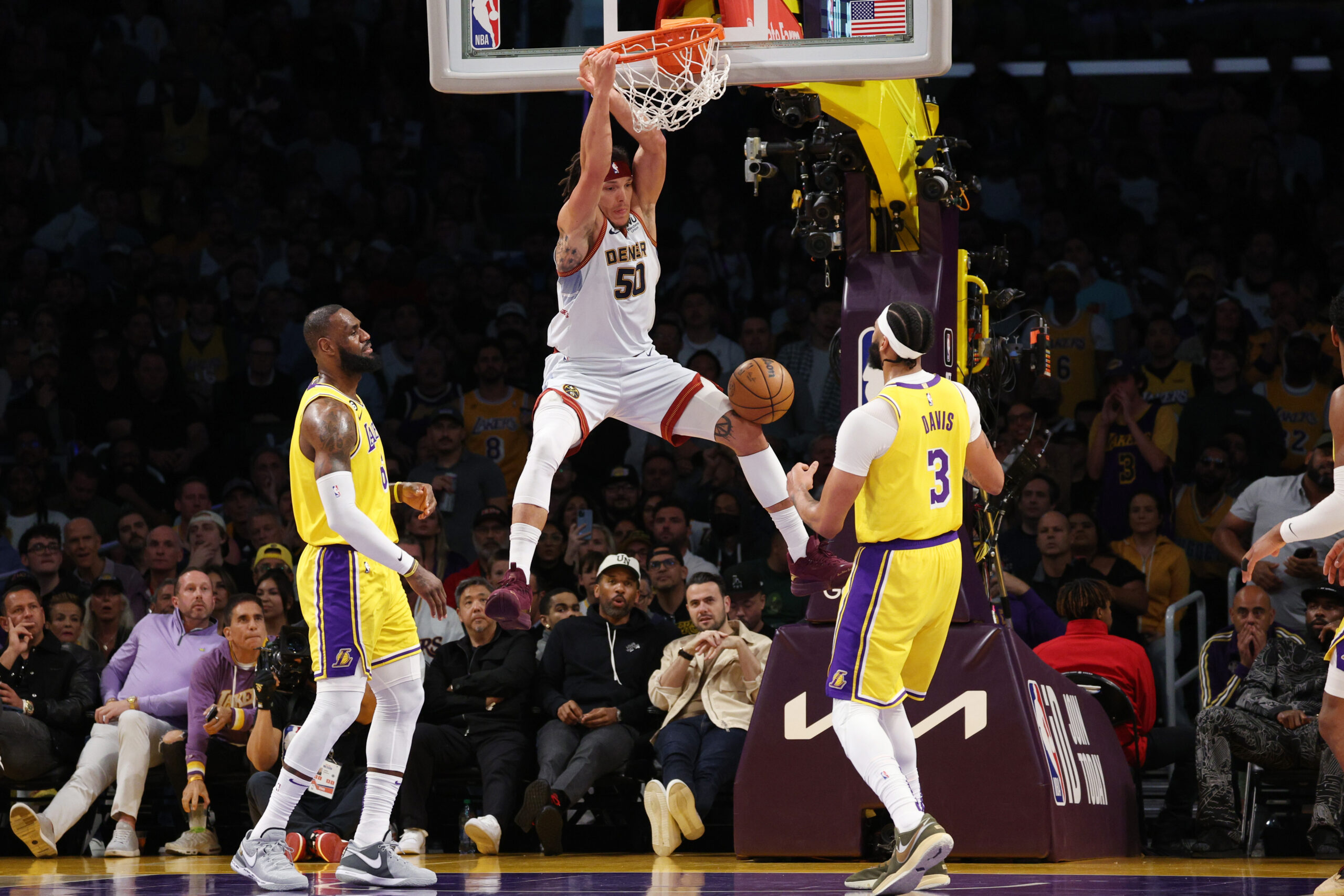 Aaron Gordon #50 of the Denver Nuggets dunks the ball between LeBron James #6 and Anthony Davis...