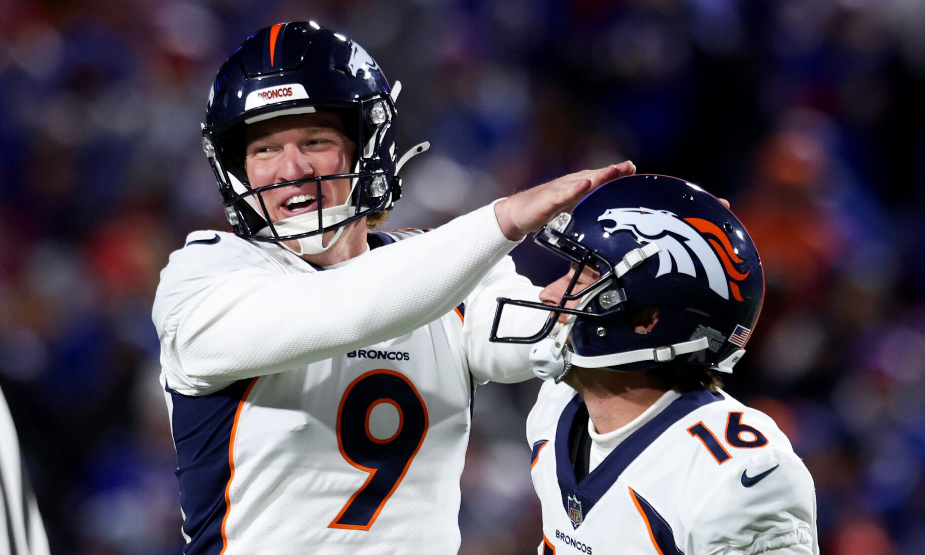 Riley Dixon #9 and Wil Lutz #16 of the Denver Broncos...